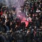 French anti-riot police officers arrive as supporters light a flare at half-time during the French Cup  match between Paris FC and Lyon