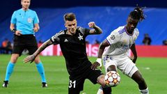Sebastien Thill, in black, battling with Real Madrid's 30-million euro teenage midfielder Eduardo Camavinga