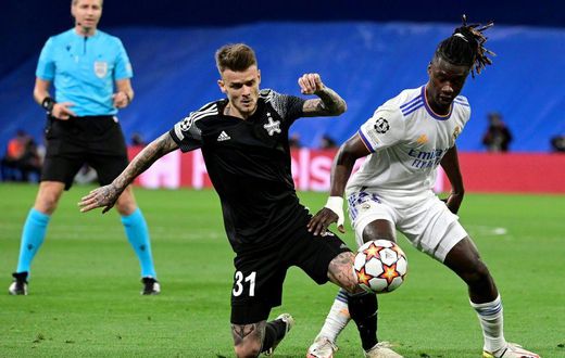Sebastien Thill, in black, battling with Real Madrid's 30-million euro teenage midfielder Eduardo Camavinga