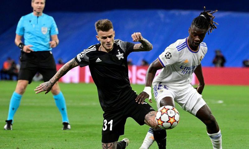 Sebastien Thill, in black, battling with Real Madrid's 30-million euro teenage midfielder Eduardo Camavinga