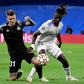 Sebastien Thill, in black, battling with Real Madrid's 30-million euro teenage midfielder Eduardo Camavinga