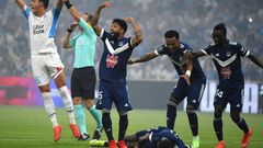 Bordeaux and Marseille's players call for medical help as Samuel Kalu lies on the ground