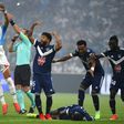 Bordeaux and Marseille's players call for medical help as Samuel Kalu lies on the ground
