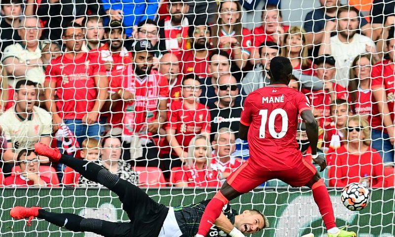 Senegalese Sadio Mane (R) scores his 100th goal for Liverpool in a 3-0 victory over Crystal Palace at Anfield