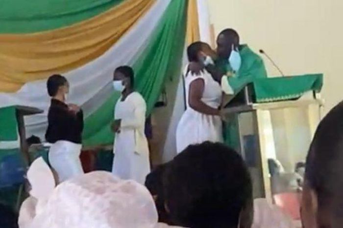 Anglican Priest kissing students
