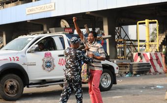 Police Task Force arresting a peaceful protester at the Lekki Toll Gate Plaza