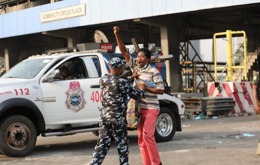 Police Task Force arresting a peaceful protester at the Lekki Toll Gate Plaza