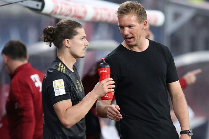 Bayern Munich head coah Julian Nagelsmann (R) speaks to Marcel Sabitzer, who made his club debut at Leipzig on Saturday
