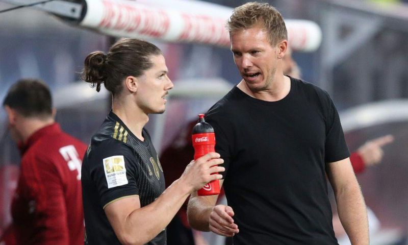 Bayern Munich head coah Julian Nagelsmann (R) speaks to Marcel Sabitzer, who made his club debut at Leipzig on Saturday