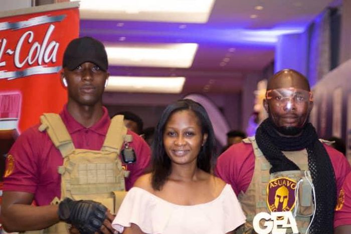 One of Asuavo Security Company's guards (right) displaying the plaque.