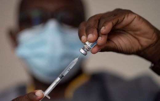 In this Wednesday, July 28, 2021 file photo, a health worker administers a dose of Janssen COVID-19 vaccine by Johnson & Johnson in the Medina neighborhood in Dakar, Senegal.