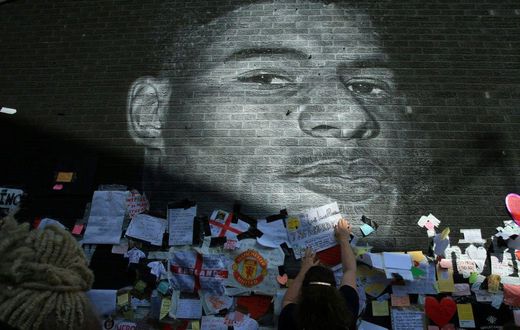 Messages of support adorn a mural of Manchester United and England forward Marcus Rashford after it was defaced
