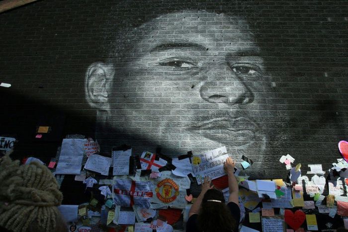 Messages of support adorn a mural of Manchester United and England forward Marcus Rashford after it was defaced