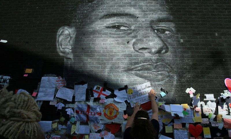 Messages of support adorn a mural of Manchester United and England forward Marcus Rashford after it was defaced