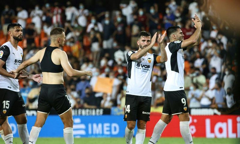 Winning start: Valencia's players celebrate