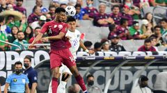 Qatar's Homam Ahmed, left, battles for a header with El Salvador's Bryan Tamacas during the Concacaf Gold Cup quarter-final match in Arizona