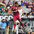 Qatar's Homam Ahmed, left, battles for a header with El Salvador's Bryan Tamacas during the Concacaf Gold Cup quarter-final match in Arizona