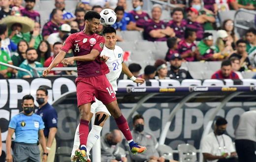 Qatar's Homam Ahmed, left, battles for a header with El Salvador's Bryan Tamacas during the Concacaf Gold Cup quarter-final match in Arizona