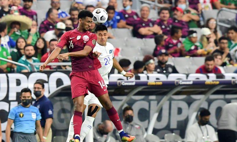 Qatar's Homam Ahmed, left, battles for a header with El Salvador's Bryan Tamacas during the Concacaf Gold Cup quarter-final match in Arizona