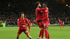 Divock Origi (right) scored in stoppage time to take Liverpool top of the Premier League