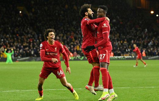 Divock Origi (right) scored in stoppage time to take Liverpool top of the Premier League