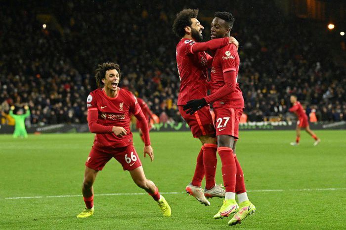 Divock Origi (right) scored in stoppage time to take Liverpool top of the Premier League