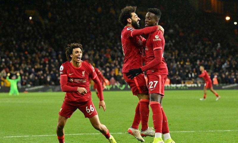 Divock Origi (right) scored in stoppage time to take Liverpool top of the Premier League