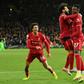 Divock Origi (right) scored in stoppage time to take Liverpool top of the Premier League