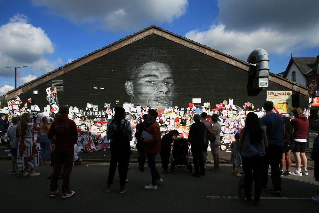 A mural of England forward Marcus Rashford in Manchester was defaced by racist abuse but soon wellwishers had covered the graffiti with messages of support