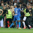 Flash point: Security try to hold back fans as they invade the pitch  at Nice's Allianz Riviera Stadium