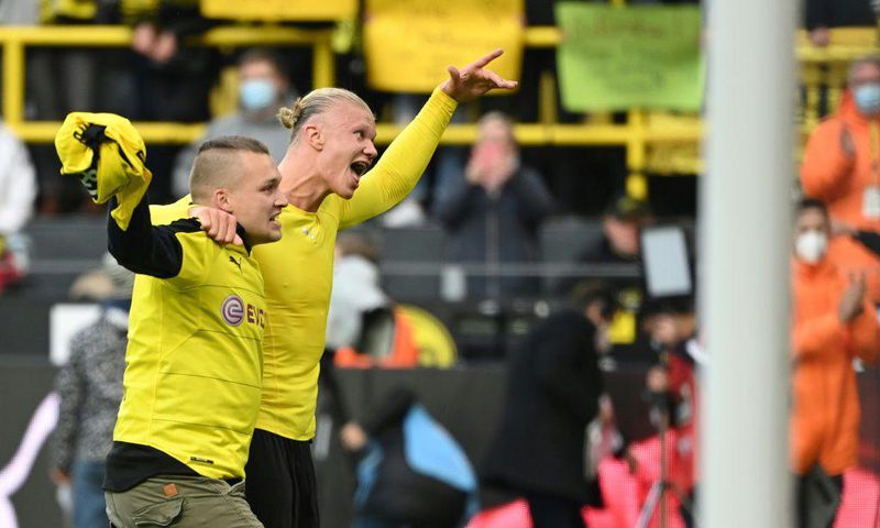 Dortmund's Norwegian forward Erling Braut Haaland celebrates with a fan after scoring twice against Mainz on Saturday