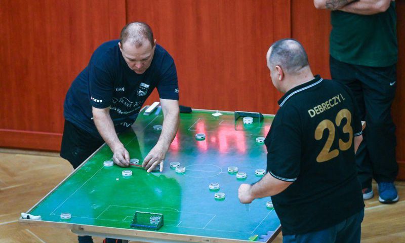 Flicking a coin-shaped disc around a table-top, Hungarians still adore the simple sport of button football, a game they invented a century ago.