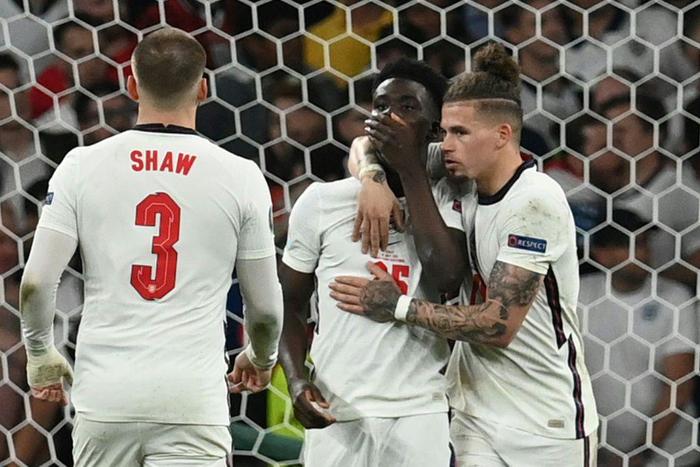 England's Bukayo Saka (C) was among those receiving racial abuse online