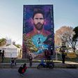 Someone to look up to: a mural of Lionel Messi looms over the playground of his former school
