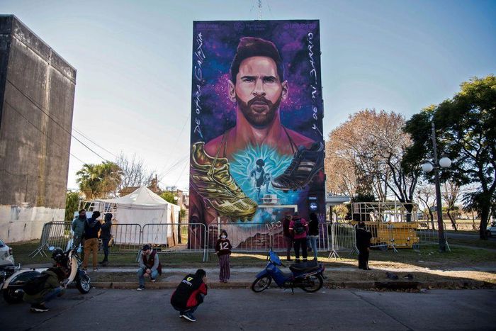 Someone to look up to: a mural of Lionel Messi looms over the playground of his former school