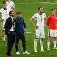 England manager Gareth Southgate (L) and his players after the Euro 2020 final