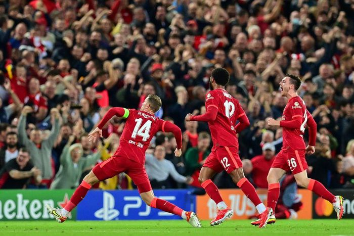 Jordan Henderson (left) celebrates scoring Liverpool's winner against AC Milan