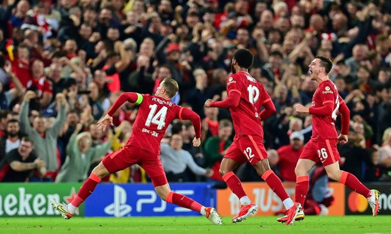 Jordan Henderson (left) celebrates scoring Liverpool's winner against AC Milan