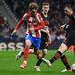 Atletico Madrid's Antoine Griezmann (L) vies with AC Milan's Italian defender Alessio Romagnoli (R) on Wednesday