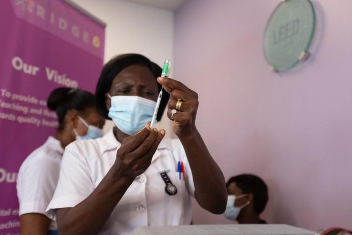 A health worker holds up the AstraZeneca vaccine at the Ridge Hospital in Accra, Ghana, on March 2, 2021.
