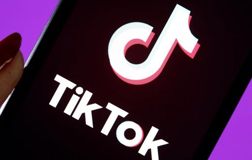 The social media application logo, Tik Tok is displayed on the screen of an iPhone.
