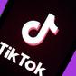 The social media application logo, Tik Tok is displayed on the screen of an iPhone.