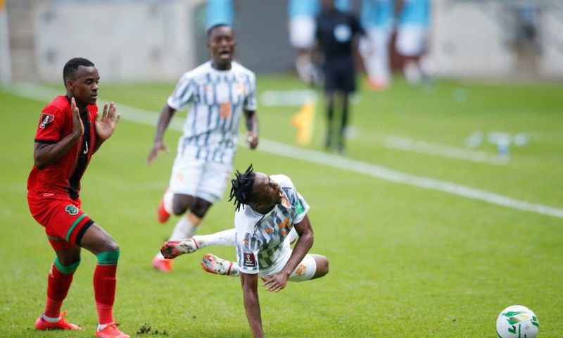 Christian Kouame (R) of the Ivory Coast is fouled by Charles Petro (L) of Malawi during a World Cup qualifier in Soweto, South Africa, on Friday.
