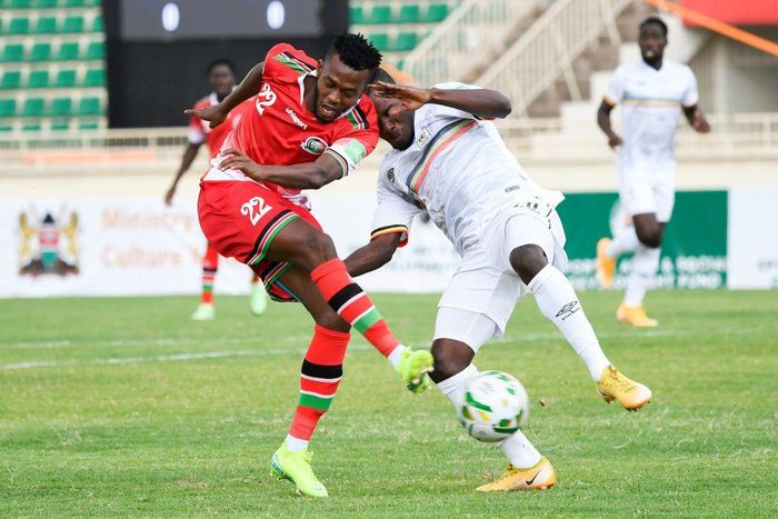 Kenyan Hassan Abdallah (L) shoots under pressure from Ugandan Isaac Muleme (R) during a 2022 World Cup qualifier in Nairobi