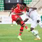 Kenyan Hassan Abdallah (L) shoots under pressure from Ugandan Isaac Muleme (R) during a 2022 World Cup qualifier in Nairobi