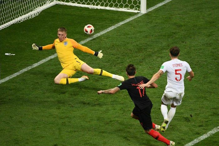 Semi-final flourish: Mario Mandzukic beats England's Jordan Pickford and Harry Maguire to put Croatia into the World Cup final.
