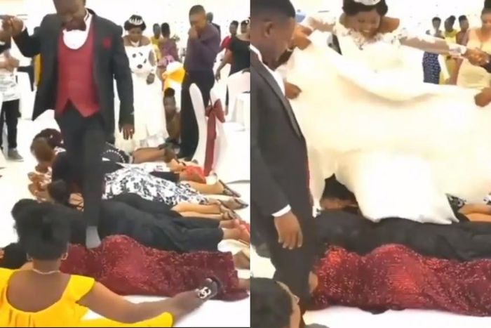 Bride and groom walk on the backs of guests at their wedding reception (video)