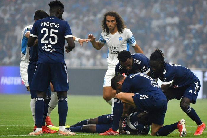 Moment of worry: Bordeaux players surround Nigerian forward Samuel Kalu after he faints on the pitch in Marseille