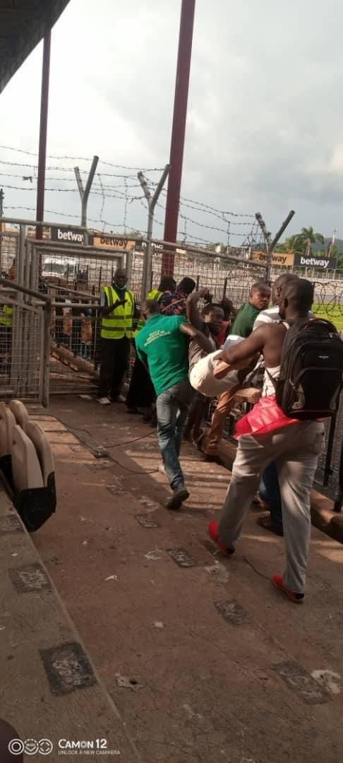 Journalist being carried out by fans