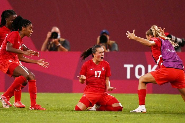 Canada's Jessie Fleming (C) celebrates after scoring the winning goal against the USA